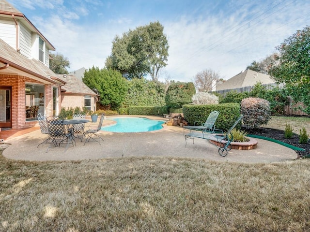 view of swimming pool with a patio area and a yard