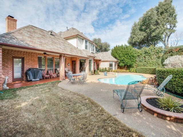 view of swimming pool with a grill, ceiling fan, and a patio