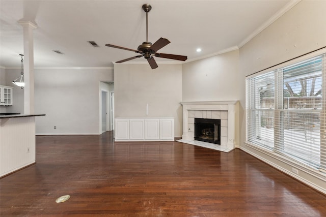 unfurnished living room with a fireplace, ceiling fan, crown molding, and dark hardwood / wood-style flooring