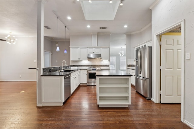 kitchen with white cabinets, stainless steel appliances, an inviting chandelier, and sink