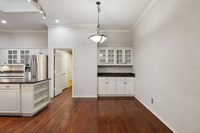 kitchen with white cabinets, stainless steel fridge, and decorative light fixtures