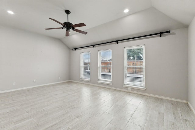 empty room with lofted ceiling and ceiling fan