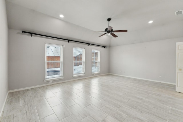 spare room with ceiling fan and vaulted ceiling