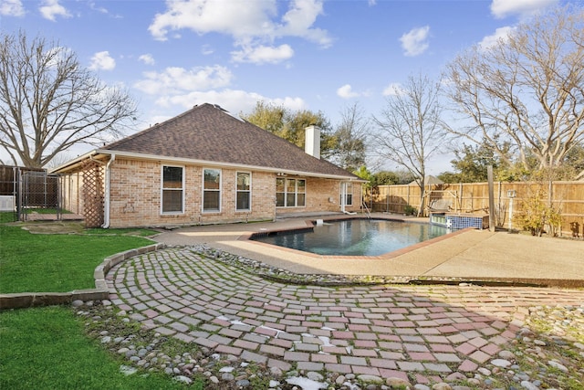 view of swimming pool with a patio and a yard