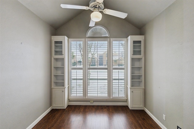 spare room with ceiling fan, lofted ceiling, and dark hardwood / wood-style floors