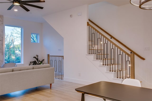 living room with light hardwood / wood-style floors and ceiling fan