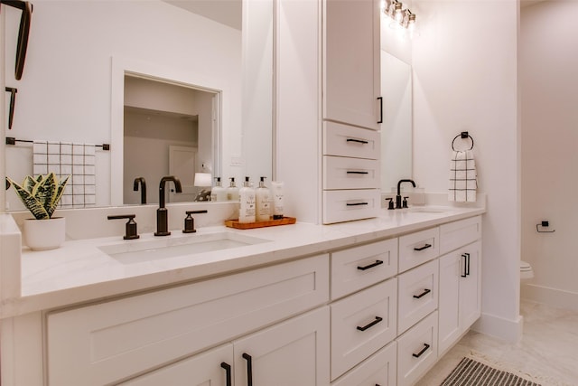 bathroom with vanity and toilet