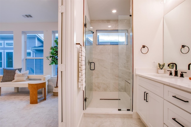 bathroom featuring vanity and a shower with shower door