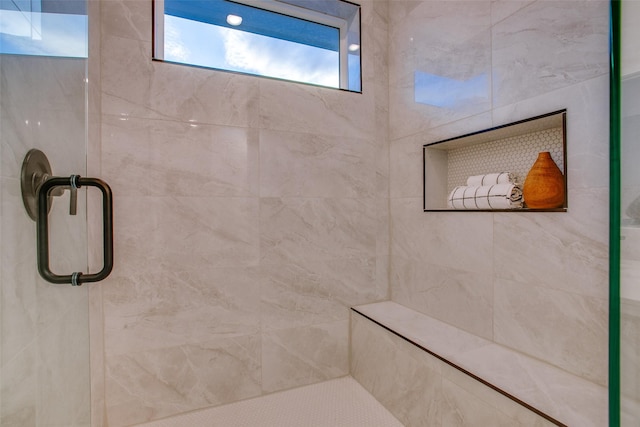 bathroom with a shower with shower door