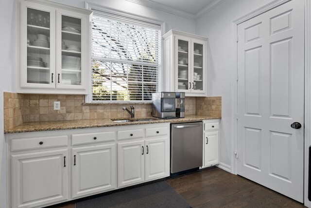 kitchen featuring light stone countertops, dishwasher, sink, decorative backsplash, and white cabinets