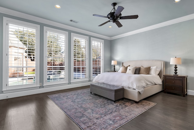 bedroom with ceiling fan, dark hardwood / wood-style flooring, and ornamental molding