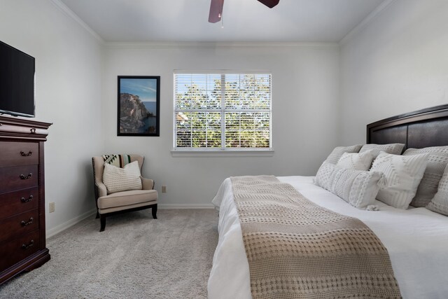 bedroom featuring ceiling fan, light carpet, and ornamental molding