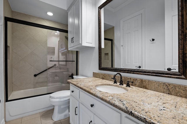 full bathroom featuring shower / bath combination with glass door, tile patterned flooring, vanity, and toilet