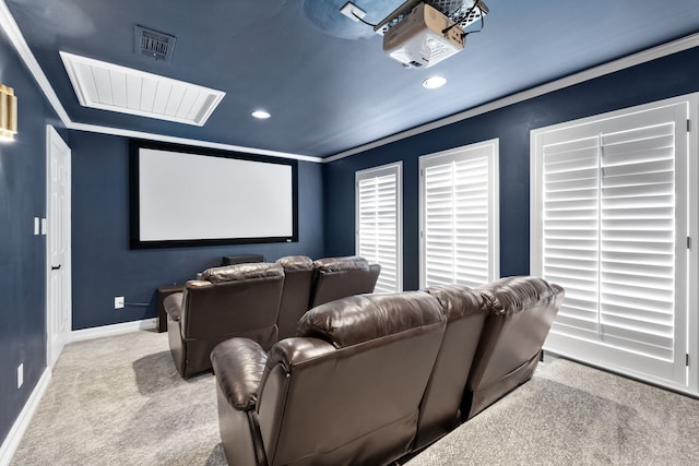 carpeted home theater featuring crown molding