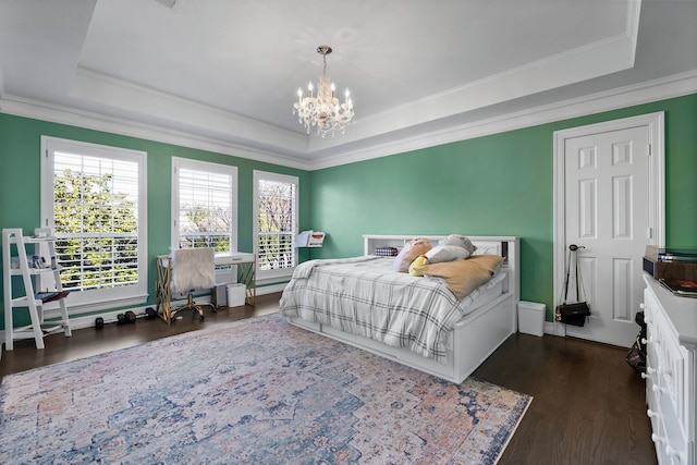 bedroom featuring a tray ceiling, dark hardwood / wood-style floors, and a notable chandelier