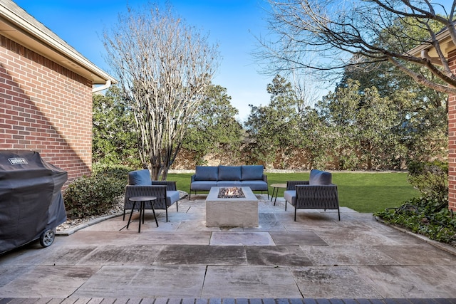 view of patio featuring grilling area and an outdoor living space with a fire pit