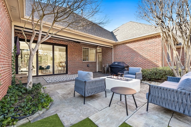 view of patio / terrace featuring area for grilling and an outdoor living space with a fire pit