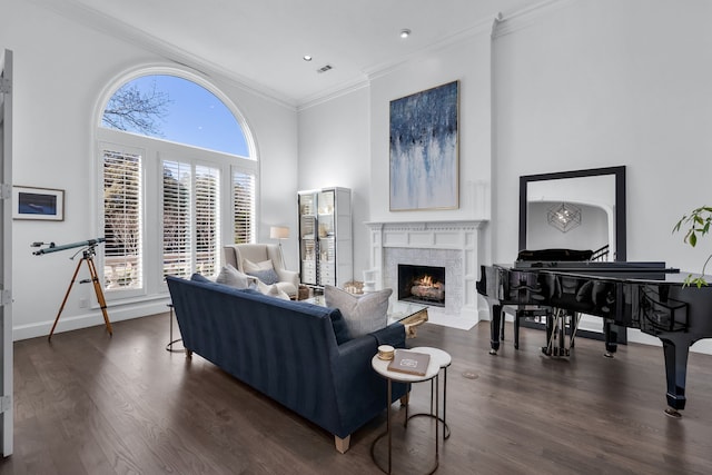 living room with crown molding and dark wood-type flooring