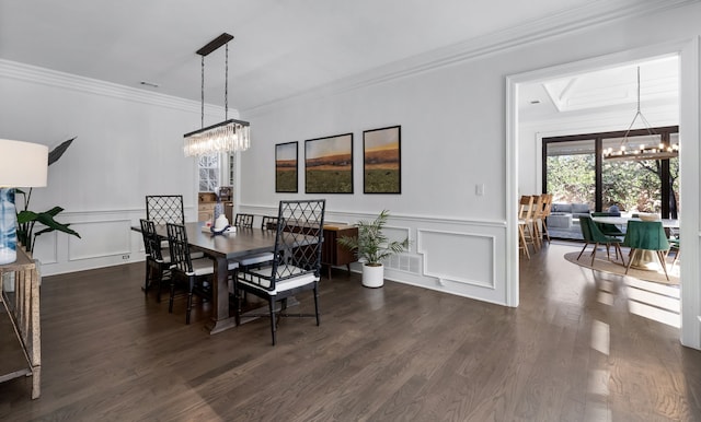 dining space with ornamental molding, dark hardwood / wood-style flooring, and a notable chandelier