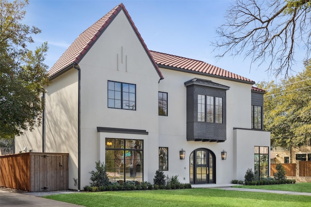 view of front facade featuring french doors and a front lawn