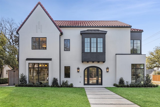 mediterranean / spanish-style house featuring a front lawn