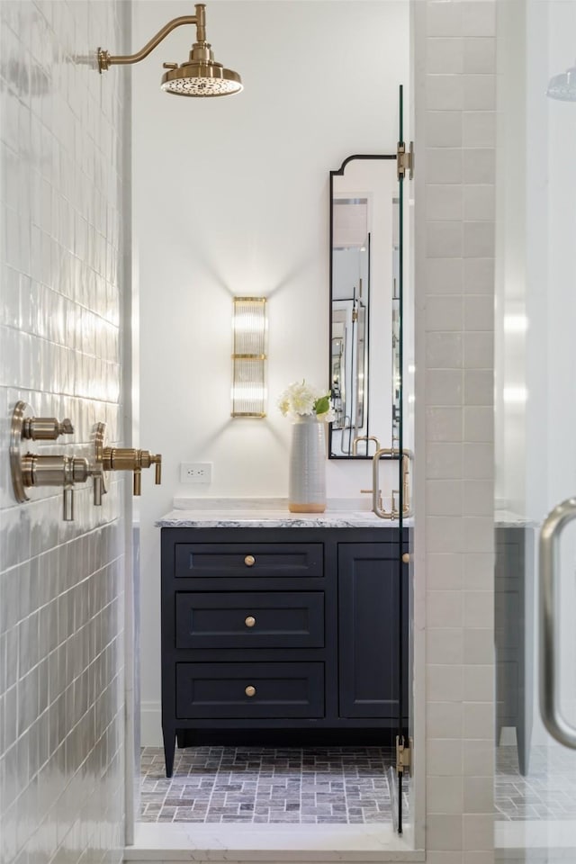 bathroom with vanity, tile walls, and walk in shower