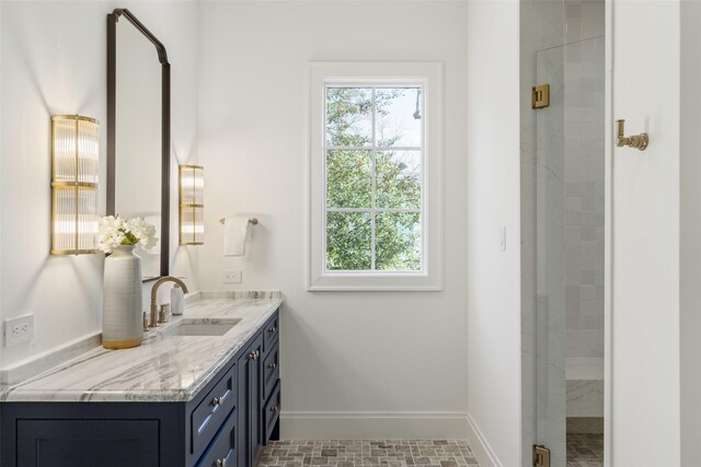 bathroom featuring vanity and a shower with shower door