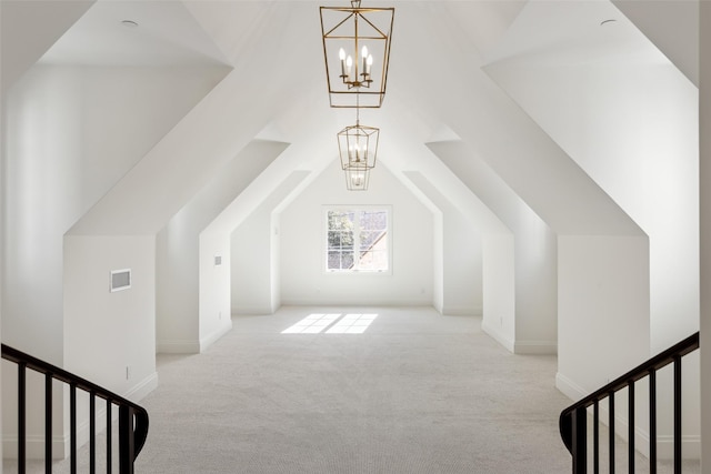 additional living space featuring a notable chandelier, lofted ceiling, and light carpet