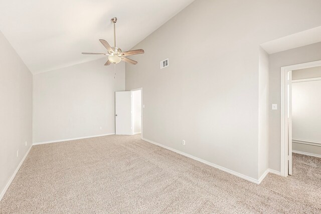 unfurnished room with light colored carpet, high vaulted ceiling, and ceiling fan