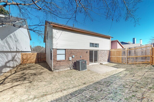 rear view of house featuring central air condition unit and a patio