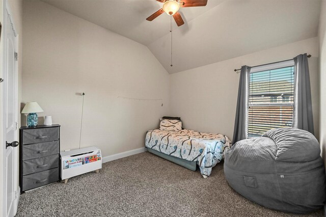 carpeted bedroom featuring vaulted ceiling and ceiling fan