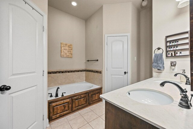 bathroom with tile patterned floors, vanity, and a bathing tub