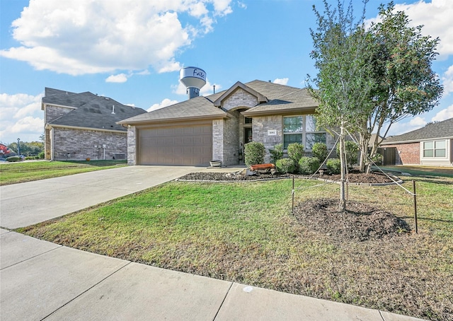 view of front of property with a garage and a front yard