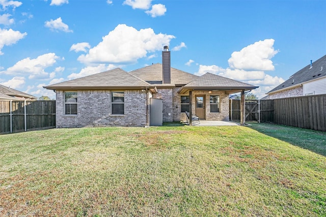 rear view of property with a yard