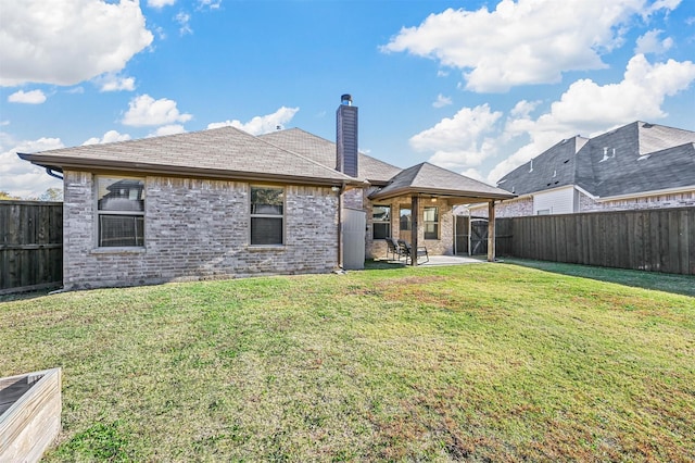 rear view of property with a patio area and a yard