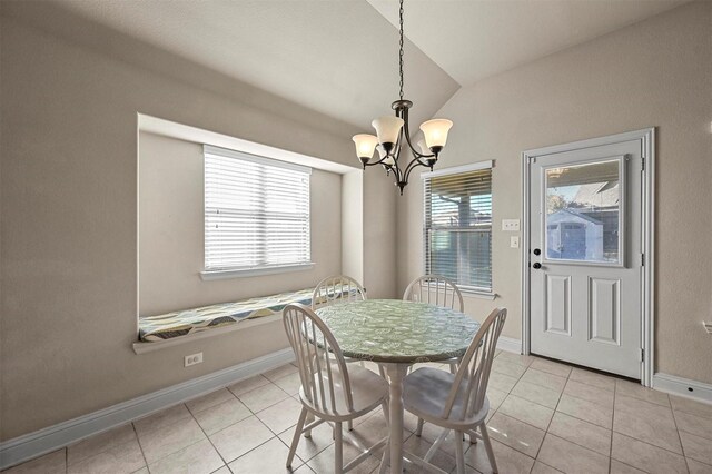 tiled dining area featuring a notable chandelier and lofted ceiling