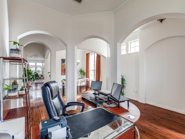 office area featuring crown molding, dark hardwood / wood-style floors, and a wealth of natural light