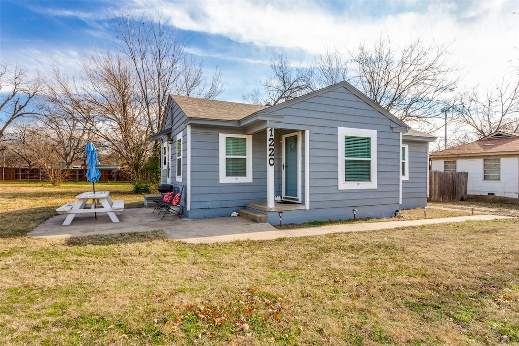 bungalow-style house with a patio area and a front yard