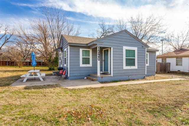 bungalow-style house with a patio area and a front yard