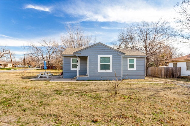 view of front of home with a patio area and a front yard