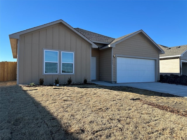 ranch-style home with a garage and a front lawn