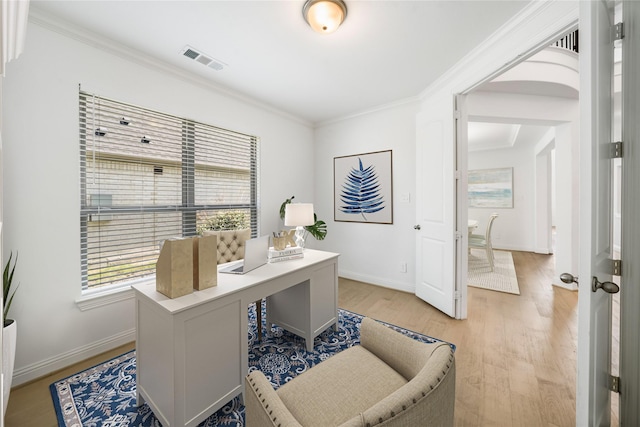 office space featuring light wood-type flooring and ornamental molding