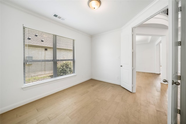 unfurnished room featuring light wood-type flooring and ornamental molding