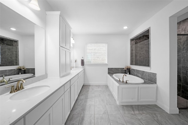 bathroom with vanity and separate shower and tub