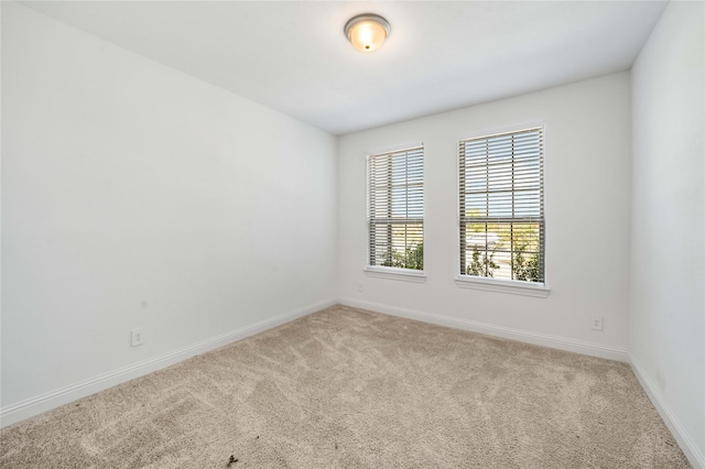 unfurnished room with light colored carpet