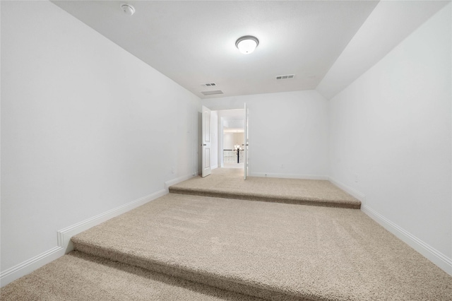 corridor featuring carpet and lofted ceiling