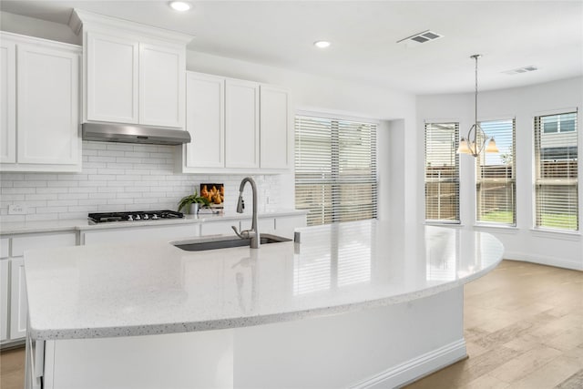 kitchen featuring sink, white cabinets, and a notable chandelier