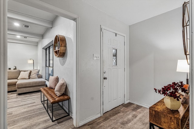 entrance foyer with beamed ceiling and hardwood / wood-style flooring