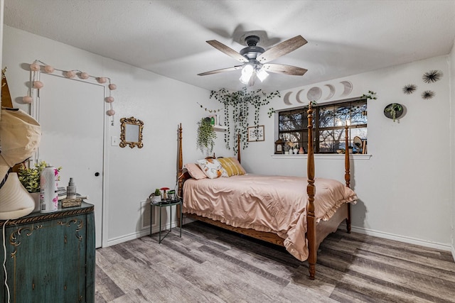 bedroom featuring hardwood / wood-style flooring, ceiling fan, and a textured ceiling