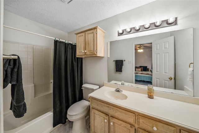 full bathroom featuring a textured ceiling, ceiling fan, toilet, shower / bath combination with curtain, and vanity